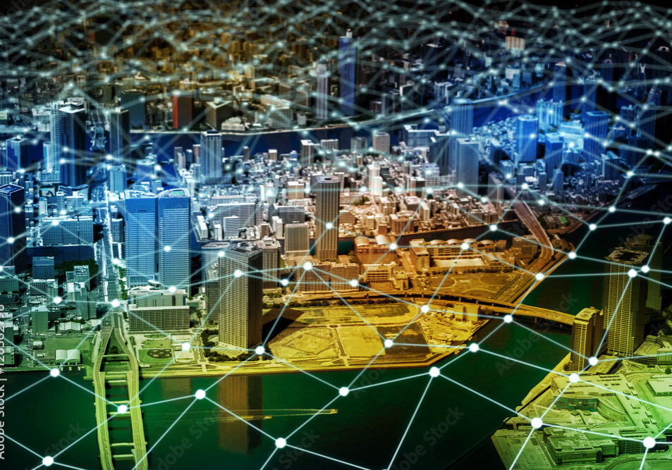 modern-city-diorama-and-network-grid-pattern-internet-sensor-network-smart-grid-abstract-image-visual-stockpack-adobe-stock A city overlaid with a set of lines and nodes representing the grid that powers the buildings.